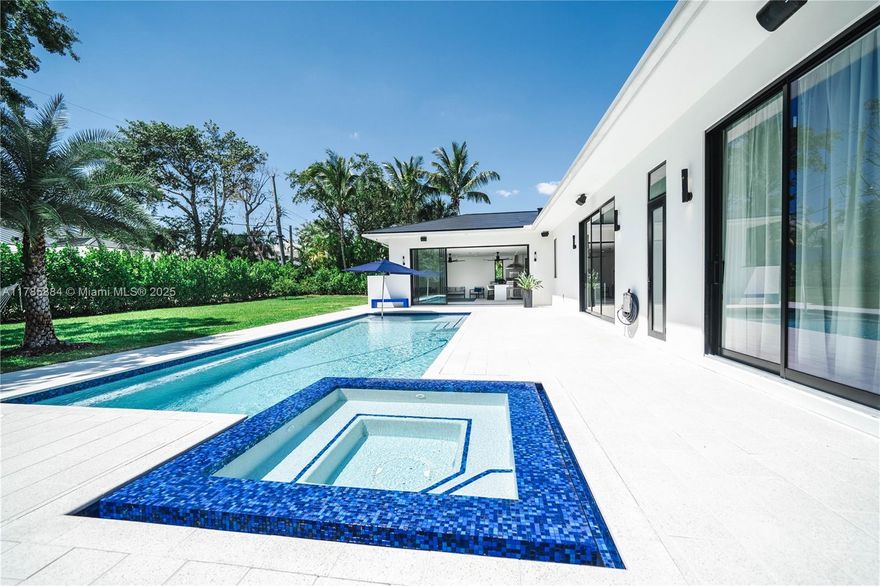 Extraordinary new construction estate offering 4,401 SF of luxurious living space with cutting-edge home automation and sustainable features. This technological marvel showcases comprehensive smart home integration—controlling lighting, appliances, climate systems, and security with a touch. The self-sufficient solar power system with roof tiles and four large storage batteries ensures complete energy independence. The seamless indoor-outdoor lifestyle unfolds through floor-to-ceiling impact sliders, leading to a resort-style pool and custom treehouse. Premium finishes with 48inch porcelain tiles, 10ft ceilings, and a modern European kitchen with Thermador appliances and quartz waterfall countertops. Features incl. a full outdoor kitchen, custom closet cabinetry, and European fixtures.