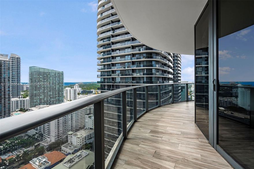 Three parking spaces, dedicated storage on the same floor, and every available developer upgrade. Private elevator. Wraparound balcony. Three bedrooms wrapped in floor-to-ceiling glass on the 29th floor of one of Brickell's most coveted towers, never leased and meticulously kept by its original owners.
The 01 line at SLS LUX is a corner residence designed to feel more like a single-family home in the sky than a condo. The elevator opens directly into a private foyer. Living, dining, and the primary suite all open onto a wraparound terrace with bay, skyline, and tennis-court views. The expanded primary suite, fully enclosed den (currently a laundry room), and dedicated storage give this home flexibility you rarely find at this size.
Developer-grade finishes throughout: WOLF appliances, marble countertops, Italian cabinetry, wine cooler, motorized blinds, smart lighting with voice control, and high-impact glass on every opening. Three parking spaces (two assigned without lift, one valet) and attached storage on the same floor included; ownership not divided.
SLS LUX delivers full resort living: multiple pools with cabanas, spa with steam rooms, fitness center, tennis court, mini-golf and multi-sport court, residents' lounges, BBQ areas, concierge, valet, and 24-hour security. Steps from Brickell City Centre, Mary Brickell Village, and Miami's most walked dining and shopping corridor.
Owner-occupied, never rented, completely renovated, and priced to transact. Offers welcome.