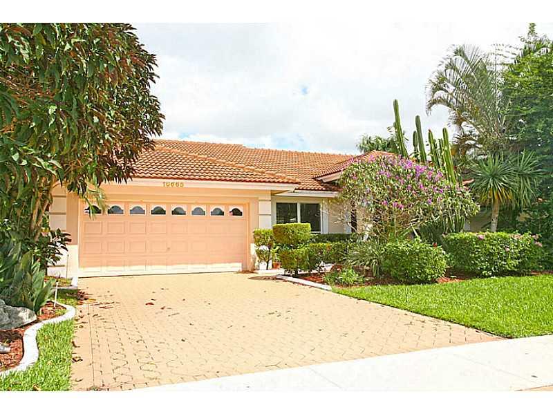 Spectacular Lake Front Home in exclusive Westport neighborhood in Plantation. Beautiful bright and light in all areas. Split plan with a huge master bedroom with it's own sitting area surrounded with a bay window overlooking the lake. Master bathroom has jacuzzi and walk in shower. This is a very clean property that will make even the most demanding customer fall in love. Tile and wood floors throughout, with separate laundry, 2 car garage, marvelous landscaping, great sitting area to relax in the backyrd