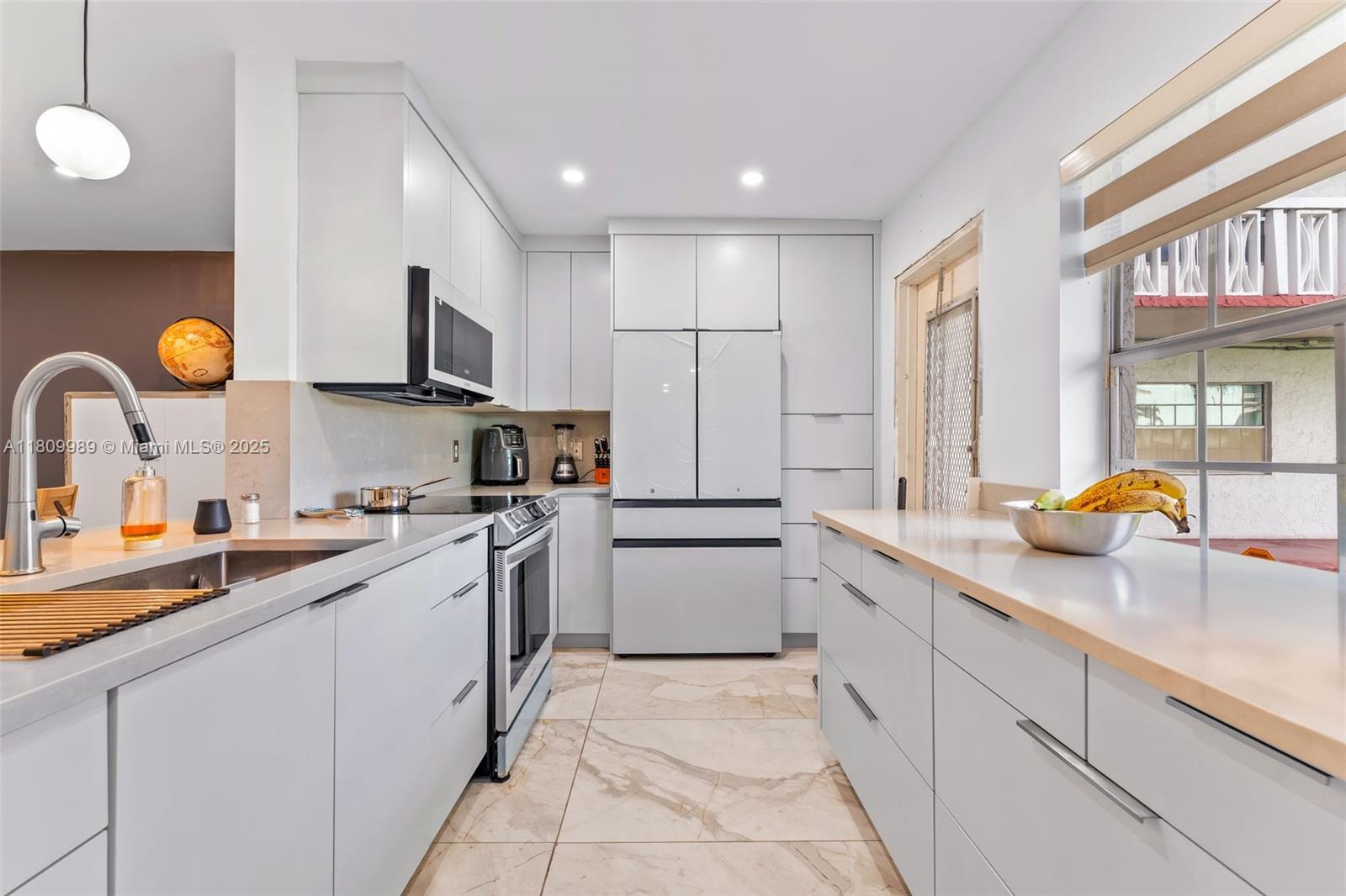 Fully Renovated 55+ Gem in Ruby Condo! Step into luxury living with this fully updated 2-bed, 2-bath condo in the sought-after Ruby Condo community. This spacious condo features a brand-new roof, modern porcelain floors, a chef-inspired kitchen with sleek white cabinetry and quartz countertops, and designer bathrooms boasting high-end fixtures, bold tile work, and custom vanities. Enjoy open-concept living with stylish lighting, impact windows, and a large private patio perfect for relaxing or entertaining. Ruby Condo offers resort-style amenities including a sparkling pool, clubhouse, and social events for active adults. Conveniently located near shops, dining, and major highways. Move-in ready—don’t miss your chance to own one of the best condos in the building!