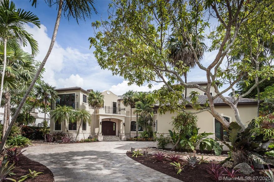 Elegant two-story home in the exclusive Cocoplum gated community. Built in 2003 with 4,901 Sq. Ft. and recently renovated, this beautiful 5BR/5+1BA home on the Coral Gables Waterway has its own private dock and pool, with balconies in the front overlooking landscaped grounds and a tranquil street. A spiral staircase in the patio leads to the terrace of the large master bedroom and seating area. Coffered ceilings with custom murals and custom-molding throughout the home offer a classic and grand look. The updated kitchen features a Thermador gas range with grill stove and warmer drawer, and Sub-Zero refrigerator and freezer with custom cabinet fronts.