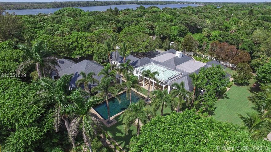 This beautifully designed, traditional Jupiter Island residence on almost a full acre (.94 acre) in prime club area location affords total privacy and features the best of tropical living. The 6000+ sq. ft. main house includes 4 bedrooms each with its own bath plus spacious living, dining and entertaining areas. There is a 1600+ sq. ft. 3 bedroom guest cottage complete with a separate living/dining room and enormous kitchen and laundry room. All of this is surrounded by lush green formal landscaping anchored by old growth trees and specimen palms. Special features include Vermont slate roof, antique Belgian block driveway and Mexican river stone pool.