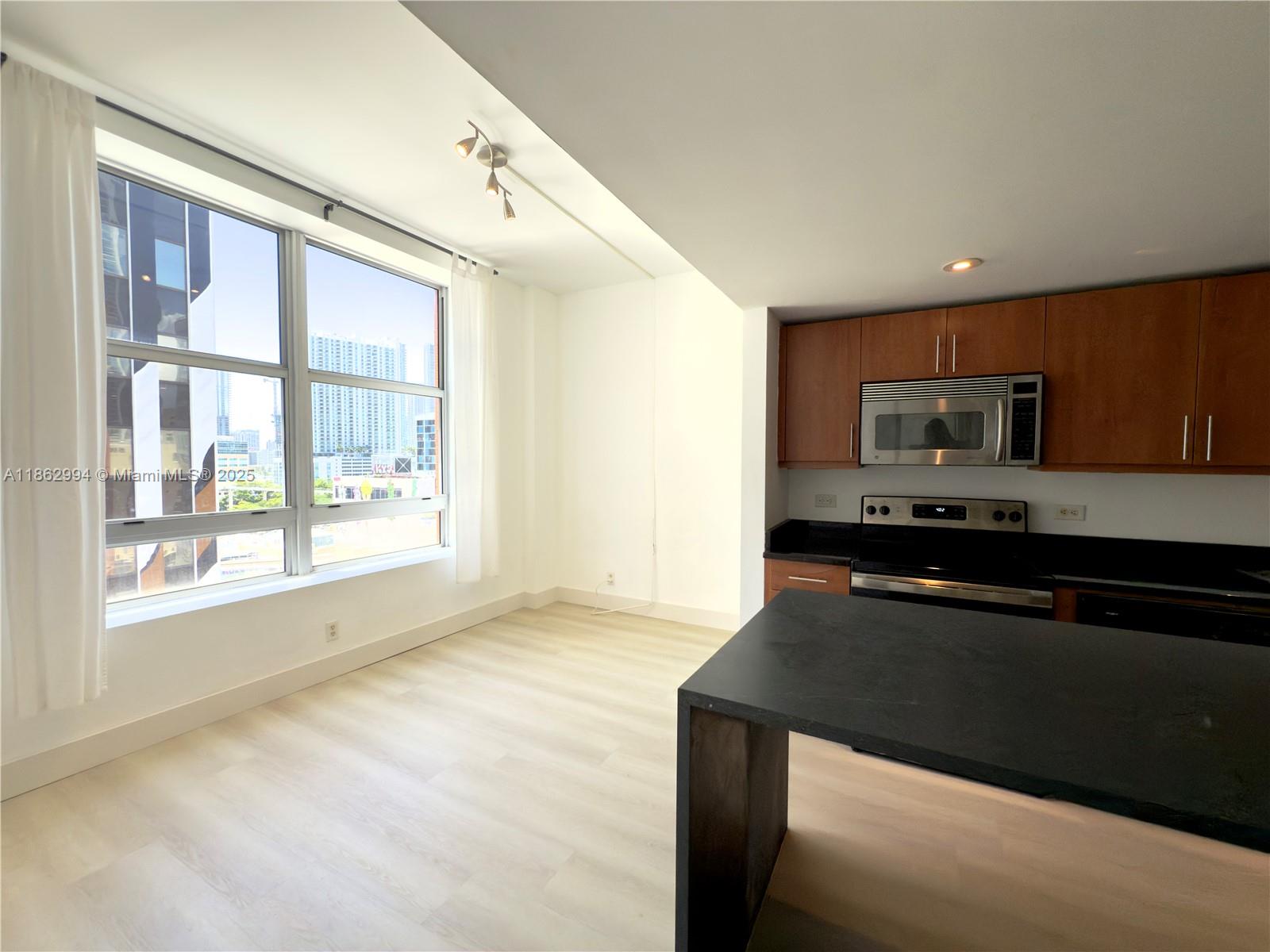 Welcome to your dream urban retreat in the heart of downtown Miami. This two bedroom condo offers the perfect blend of modern luxury and vibrant city living. Step inside and be greeted by an open-concept, fully remodeled space featuring a spacious island, perfect for cooking or casual eat in dining. Enjoy the convenience of an in-unit washer / dryer, modern appliances, brand new water heater and central air conditioning to keep you cool year-round. Expansive windows fill the space with natural light and city skyline views. This cozy, well cared for condo is steps away from the Kaseya Center & Miami's finest dining, shopping & entertainment. This is the best priced 2 bedroom in the area, perfect for investors looking for a low maintenance income property or owners ready to live in the mix.