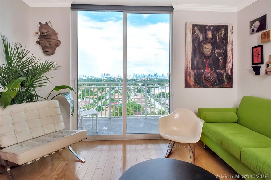 Unique corner penthouse unit with beautiful city skyline views, gorgeous real hardwood floors, custom Smith & Noble roller shades, Elfa closet shelving, and 2 inviting balconies with incredible evening panoramic views of the city. This meticulously maintained 2 bedroom, 2 bathroom unit has a split  bedroom plan that includes a spacious den which could be enclosed to into a separate room. Nice kitchen with granite countertops and stainless steel appliances. Very quiet unit as there are only 4 units on the top floor. Unit comes with 2 assigned covered parking spaces.  Building is beautifully maintained a featuring a gym, pool, secured access, covered gated parking, security cameras and visitor parking. Central location with easy to Brickell, Coral Gables, Coconut Grove and Airport.