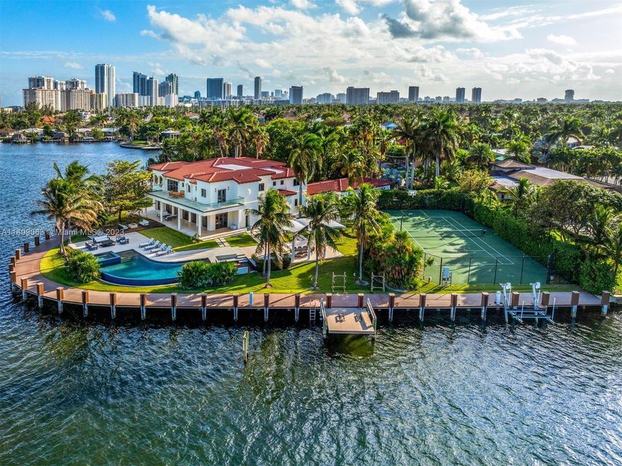 The best situated property in all of Hollywood. Embrace unparalleled luxury in this contemporary waterfront haven, situated on an expansive 48,650 sq ft point lot spanning over an acre. Revel in the stunning 430 ft of water frontage with spectacular lake views. This 6 bed and 6+2 bathrooms estate boasts an array of exquisite features. Honed limestone & American Walnut flooring grace the interior, while a curved infinity-edge pool, swim-up bar, hot tub, and full dock with boat & jet ski lifts enhance the outdoor paradise. A smart house system & art lighting seamlessly blend technology & elegance. Features include an electric driveway gate, lit tennis court facing North-South, & gazebo with an outdoor kitchen & gas fire pit. Live lavishly in this meticulously designed retreat.