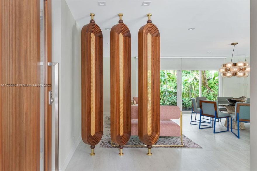 Fully renovated,4-bed, 3-bath mid-century modern home on a 12,000+ SF lot in a quiet East Miami Shores cul-de-sac. This 2,464 SF residence features sophisticated finishes and design with floor-to-ceiling impact glass bringing natural light throughout the house. The gourmet Stosa kitchen includes a 36” Monogram gas stove, quartzite counters, Wolf hood, Subzero wine cooler, Dacor fridge with dual ice makers, and Monogram wall oven. The spacious and private primary suite with spa-style bath, soaking tub, walk-thru closet, and garden views. Smart home features include Vivint security, Lutron lighting, 7-zone Bowers & Wilkins sound, dual A/C, and gas water heater. The expansive outdoor  offers a heated pool, jacuzzi, waterfall, and expansive landscaped lawn framed by oak trees.