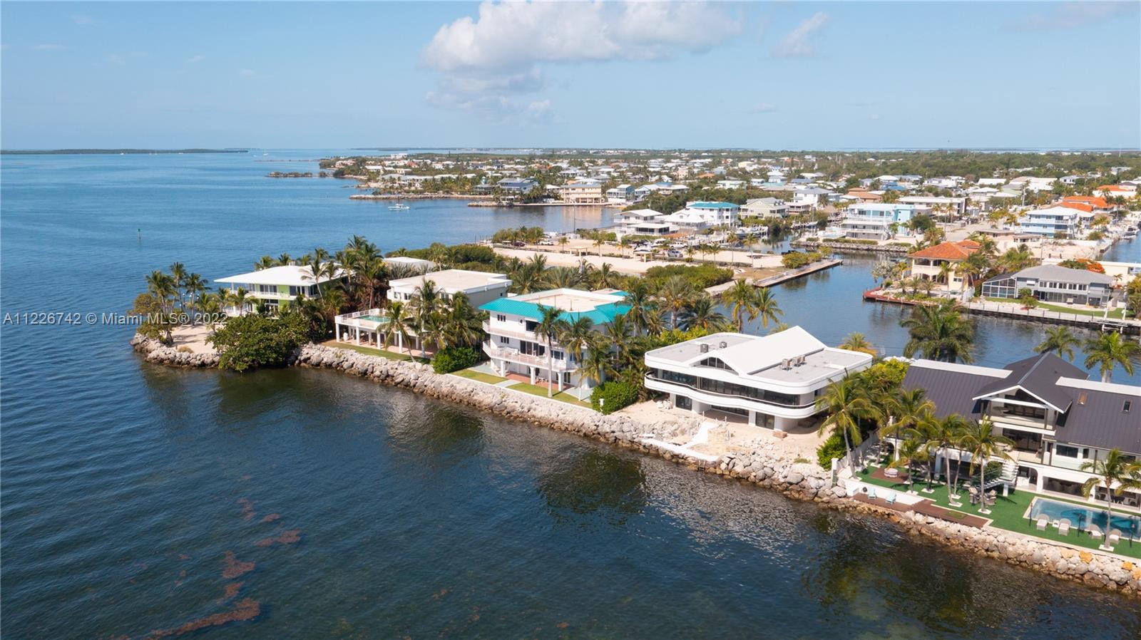 Contemporary maritime estate delivers expansive open ocean views and yacht-worthy dock. 100 ft of deep-water harborage and unobstructed immediate ocean boating access. Each room showcases water views, either oceanside sunrises or waterway sunsets. Vaulted ceilings and newly installed accordion Euro doors provide spacious indoor-outdoor living. Built with integrity and designed by the original owner, architect Clement DiFillippo. Situated in Ocean Cay, a premier oceanfront gated enclave, at mile marker 100 in Key Largo, FL.