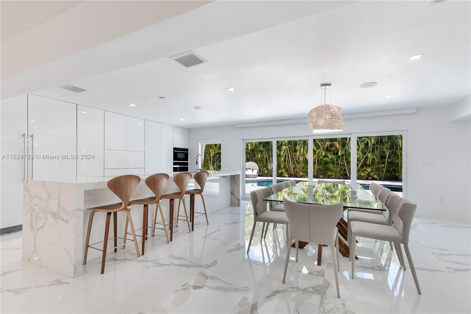 Renovated, 3,100Sqft, on a 11,800Sqft land, 4 bedrooms, option for a very large 5 bedroom, 4 bathrooms, 1 cabana bathroom, Smart Home with surround system, wired for cable and internet, electrical windows treatments, new plumbing, electrical box, electrical interior, 2 AC units, kitchen, closets, floors, bathrooms, infinity salt water heated pool, diamond brite, sprinkle system, pool pump, marble floors at deck, double and insolated impact PGT windows and doors that slide to became one panel for a large opening, front door double impact and pivot door, Sub-zero, wolf appliances, back yard with a 100% privacy, 1 room with sliding doors can be use as garage for motorcycles, enough space on the side of the house with gates to park a trailer, cover parking.