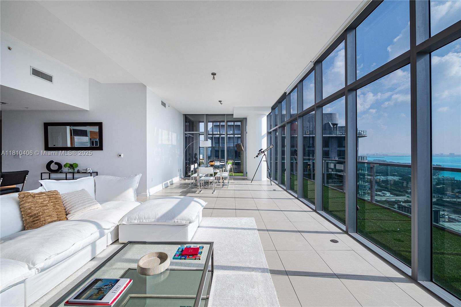 Luxury Turn-Key Residence For Rent - Welcome to an exceptional fully furnished 3-bedroom, 3-bathroom corner residence in the prestigious Four Midtown Miami. This elegantly designed condo boasts a spacious open layout, a gourmet kitchen with premium finishes, and floor-to-ceiling glass walls that showcase stunning panoramic views of Biscayne Bay and the city skyline. Wrap-around balconies extend the living space outdoors, offering the perfect setting for morning coffee or evening cocktails with a view. Each bedroom is thoughtfully appointed, blending comfort with contemporary style. Ideally located in the heart of Midtown, you’ll enjoy unmatched access to Miami’s finest dining, shopping, and cultural experiences –just minutes from the Design District, Wynwood, and Downtown.
Refined living.