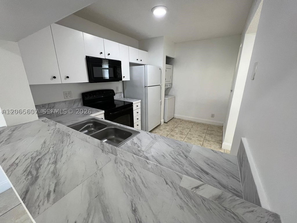 Photo of 2421 NW 56th Ave #2-103, Lauderhill, FL 33313 (MLS # A12065607)