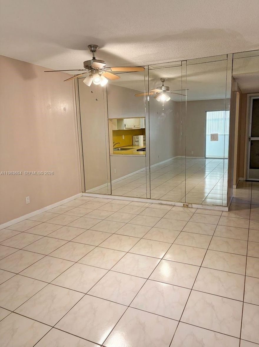 Spacious 2bd/2ba corner unit in a desirable 55+ community, offering 1,074 square feet of tiled living space. Thoughtfully designed split-bedroom layout, abundant windows for natural light, and generous closet space throughout. Features include an eat-in kitchen with a window, white appliances, plus a fairly recent A/C and water heater. The complex has already completed its 50-year recertification and milestone inspection for added peace of mind. Vacant and easy to show. Prime location directly across from Gulfstream Racing & Casino, with shops, restaurants, and the beach just minutes away.