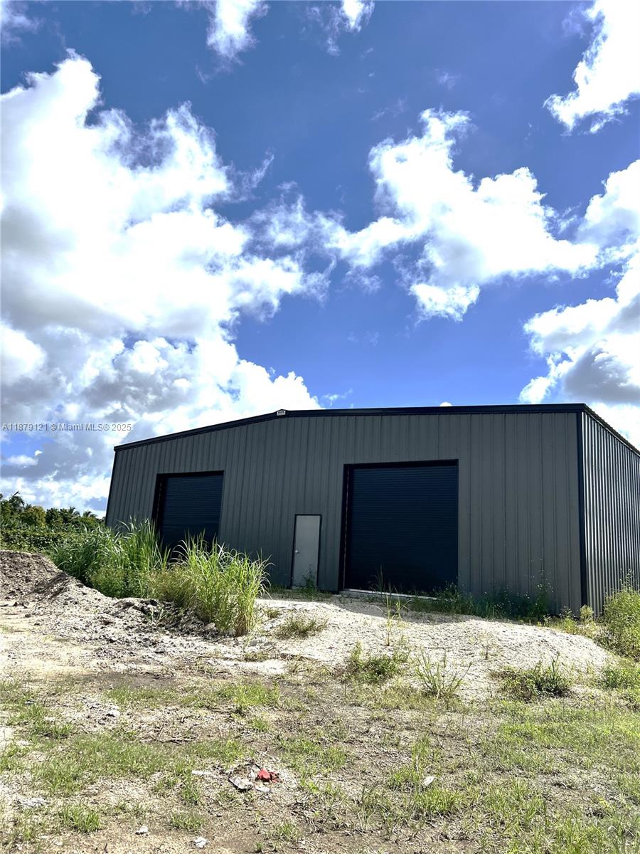 40ft X 40ft new constructed Warehouse with 2 roll up garage doors, and a walk in door. Pavement floor and metal rood, this building has infinite opportunities for use. It sits on 4.5 Acres that can be used along side the warehouse for any storage and/or Agricultural use. 2 Well access points on site. In a great location off krome Avenue and close to kendall area, but with the privacy that is 187th Avenue.