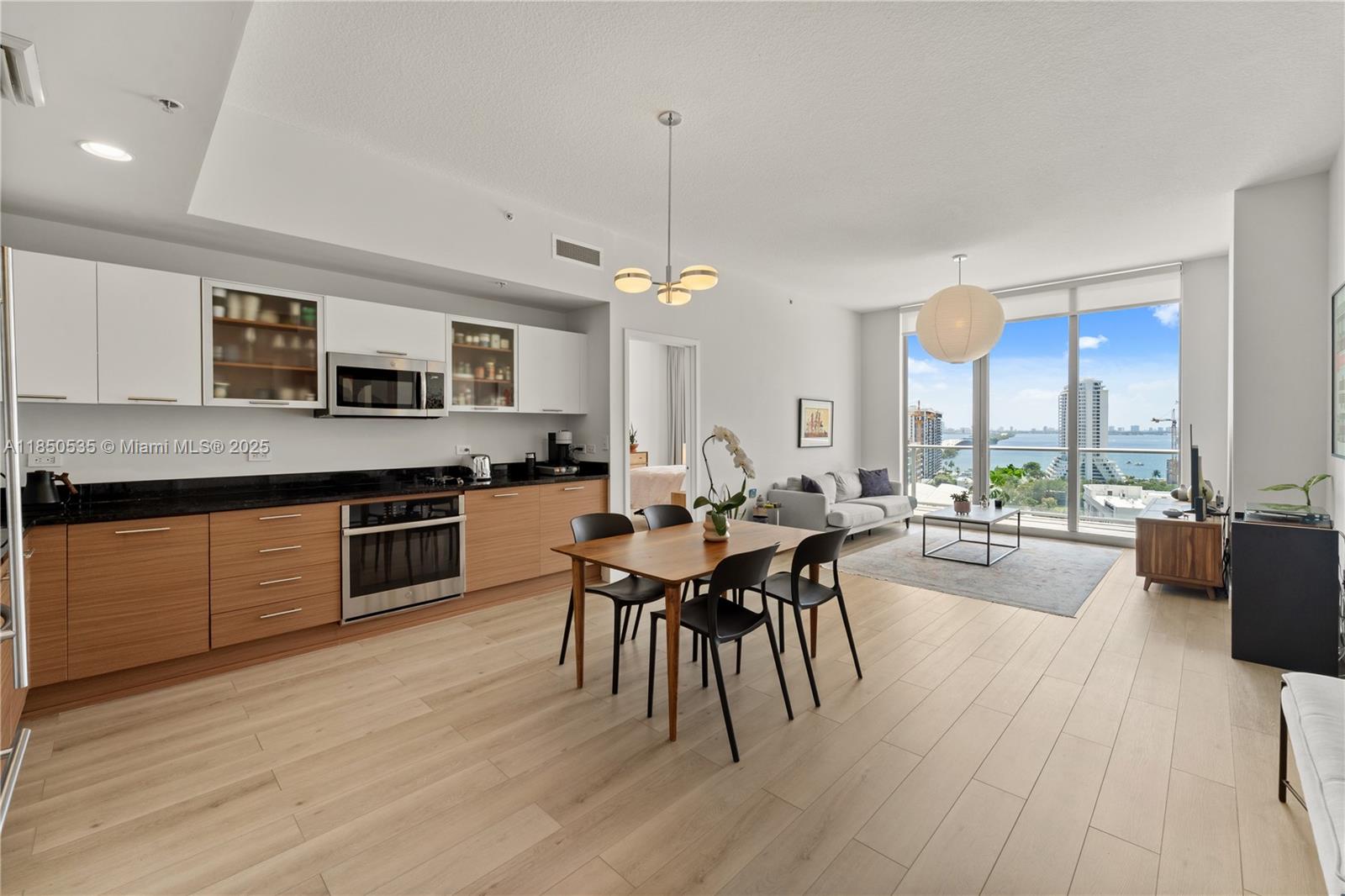 Live in the heart of Midtown Miami in this beautifully renovated 2BD, 2.5BA residence in one of the area’s most coveted buildings. Soaring ceilings, floor-to-ceiling windows, and a large balcony showcase stunning Biscayne Bay views. Inside, enjoy a bright open layout with an upgraded kitchen, renovated baths, and new flooring throughout—perfect for entertaining or working from home. Step outside to Whole Foods, Trader Joe’s, premier fitness studios, and Michelin-starred dining, with the Design District and Wynwood just minutes away. Residents enjoy 24-hour concierge and security, a sleek fitness center, resort-style pool, sauna, and a chic outdoor lounge with fireplace. This is elevated city living—effortless, stylish, and distinctly Miami.