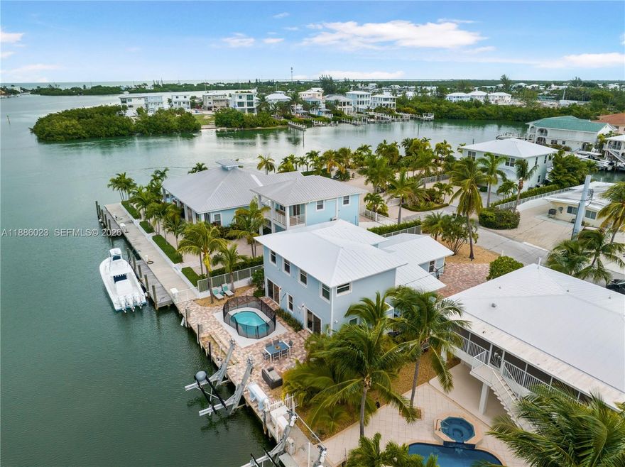 This Key Colony Beach coastal retreat blends modern elegance with waterfront tranquility is steps from Bonefish Bay. Inside, a beautifully updated kitchen with granite countertops, stainless steel appliances, and a large entertaining island opens to bright living and dining areas. A first-floor en-suite provides excellent privacy for guests or multigenerational needs. Upstairs, the primary retreat impresses with a spa bath featuring a soaking tub and separate shower, plus an oversized walk-in closet. Outdoors, boaters will enjoy the 60 foot dock with a 15K-lb lift and quick access to the ocean. Proven vacation rental history offers the rare blend of lifestyle enjoyment and potential income.  Cabana Club membership, par-3 golf, tennis, and pickleball courts. —embrace the Florida Keys lifestyle!