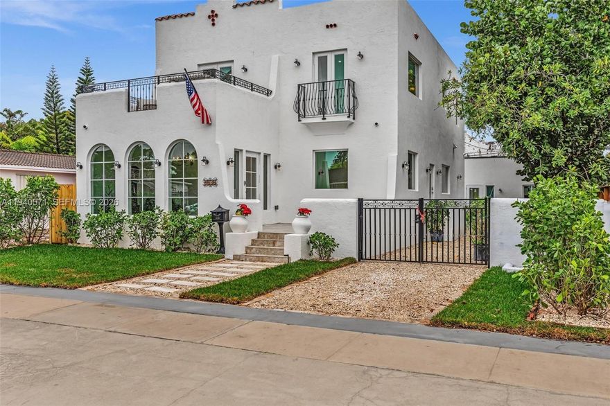 Beautifully renovated two-story Mediterranean residence with a fully detached guest house. The main home features arched windows, elegant tilework, and a bright open layout anchored by a designer kitchen with custom cabinetry, quartz waterfall island, double ovens, and statement vent hood. Living and dining areas flow seamlessly, highlighted by a fireplace, decorative tiled stair risers, and wrought-iron railings. Multiple outdoor spaces include a private upstairs terrace and a landscaped courtyard ideal for entertaining. The detached ADU offers a private entrance, deck, and garden—perfect for guests, extended family, or rental income. Gated parking, tropical landscaping, and multiple patios complete this exceptional property.