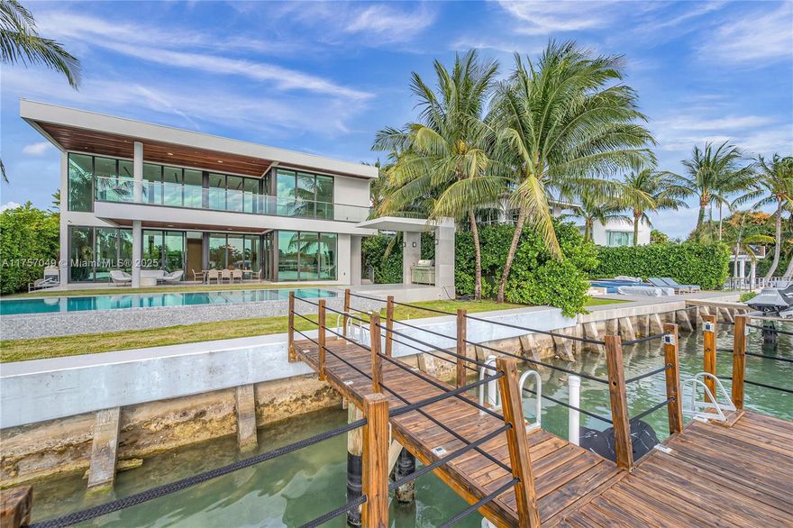 Architectural masterpiece! Built in 2020 Elegant water front 2 stories smart home dock elevator 75’ of waterfrontage ocean access no fixed bridges Concrete roof, steel, concrete & block walls, impact doors windows designed to survive extreme hurricanes. 7,000 square foot total area elegant lifestyle large outdoor entertainment infinity pool, Jacuzzi, gazebo, water front balconies 6 bedrooms suits 6.5 baths & den. Custom chef's kitchen,Wolf appliances, quartz counter tops, eat-in island, family room, large living area, gust bedroom, maid bedroom,laundry room, formal dining, luxurious direct water-facing master suite with private terrace his/her master bathrooms custom-built closets, 6 bedrooms suites and a den. Waking distance to the desired Lehrman School and to the beach