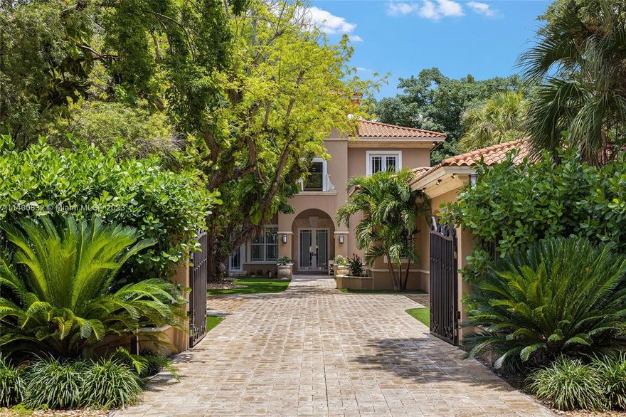This gated 2-story home in North Coconut Grove sits on almost a half-acre lot located in one of Miami's most sought-after neighborhoods. The 6BR home features a formal living room w/fireplace, formal dining room, oversized family room, an open kitchen w/quartz countertops & stainless-steel Viking appliances, Butler’s pantry, +/- 300 bottle wine cooler. Highlights include French glass doors, high ceilings, marble floors throughout, delightful courtyard, fountains & covered patio, pool area w/cabana bath, outside shower, huge backyard, summer kitchen & pizza oven. The spacious principal suite features a sunroom, principal bathroom w/dual sinks, large walk-in shower w/a sauna. All bedrooms w/electric shades, & walk-in closets. Laundry room w/sink & detached guest apartment with a carport.