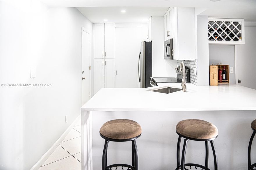 Tastefully remodeled unit, a gorgeous 2/2 with a modern open layout, eat-in kitchen.  Living room with built-in entertainment center. Custom bar with wine rack. Stunning white and grey bathroom with two shower niches and a linear drain. Unit features tile flooring throughout, stainless steel side-by-side refrigerator and front loading washer and dryer. Enjoy the amenities of this all ages community such as pool and courtyard with BBQ area. No leasing permitted
and no pets in this community.