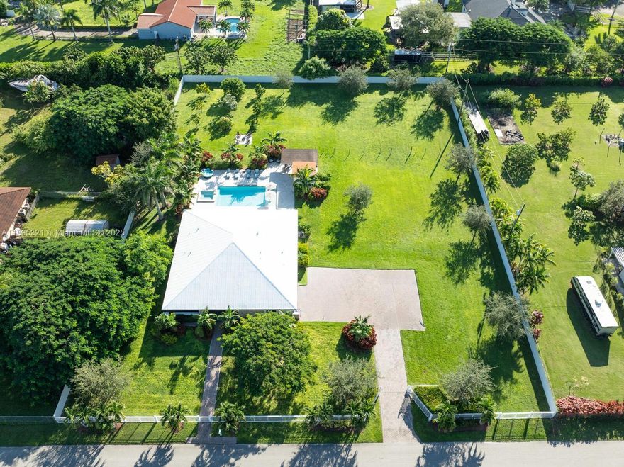 CUSTOM BUILT REDLANDS BEAUTY! Generous wide open living area. Large gourmet kitchen with huge island, top of the line appliances and beautiful quartz counter tops. Split bedroom floor plan. Large master suite which includes a large walk-in custom closet and an oversized bathroom. Large pool with beach entry, jacuzzi, patio and summer kitchen great for entertaining! Large covered front porch. Metal roof. Interior laundry room. Tile floors through out. All impact doors and windows. 54,450 Sq Ft Lot completely fenced! Plenty of room for boats, RVs and the horses! Mango Trees, Avocado Trees and Mamay Trees This meticulously maintained home is in excellent condition, move right in!
