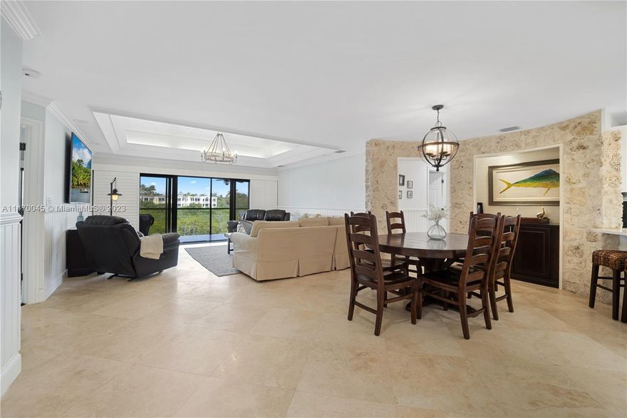 Experience unparalleled luxury at the Landings in the exclusive Ocean Reef Club®. This top-floor corner unit offers 3- bedrooms, 3- bathrooms, and a bonus bunk room for kids. Enjoy breathtaking water views of Fisherman's Cove from the oversized, screened-in porch. Fully furnished and move-in ready, this condo provides convenient access to club amenities via a short golf cart ride. Additional features include assigned floating dockage for the boat up to 31', a one-car garage, and a separate golf cart room. The common area boasts a barbecue and fish cleaning station by the docks. Discover the pinnacle of refined living at the Landings Condominium. Call now to schedule a viewing and make this dream condo your new sanctuary.