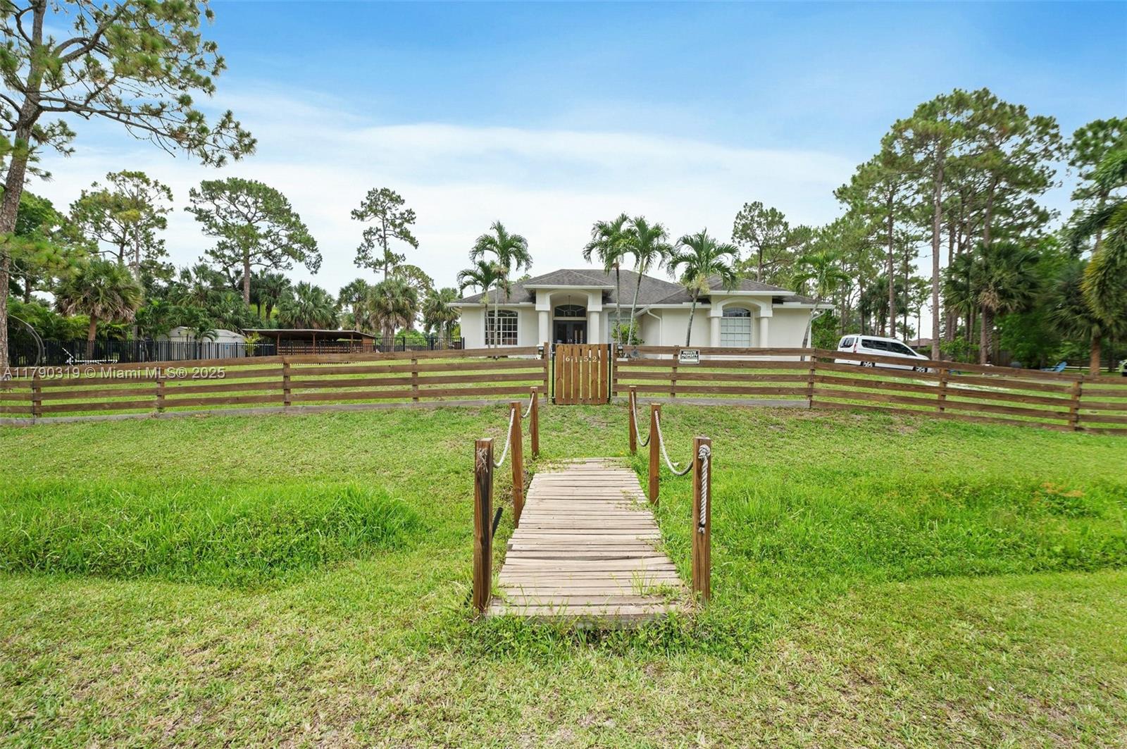 Beautifully house located in the best part of the acreage with quick and easy access to Turnpike and major throughfares. One acre plus with mature pine and Royal palm trees adorn this exceptional property. Three bedrooms plus a large office/den, high ceilings, new kitchen with quartz countertops; under the roof patio, newer Ac and new water heather ,New gutters. Heated pool and salt water surrounded by aluminum fence, horse stable and chicken coop, security camera will be include, well water, lawn and pool will be include in the rent's payment