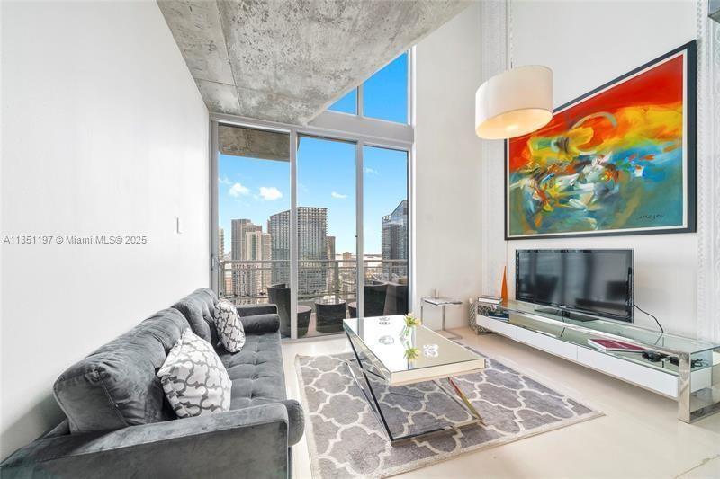 Amazing 2 story penthouse loft offering 868 sqft,1 bedroom, 1.5 bath in the heart of Brickell. As you enter this sun-filled open floor plan home you are greeted by floor to ceiling glass windows, sleek flooring, and a private balcony where you can enjoy sunrise and sunset views as boats ride along the Miami River. Enjoy cooking your favorite meals in the modern kitchen complete with stainless steel appliances, endless cabinets for storage, and ample counter space. Neo Vertika offers resort style amenities including a secure building offering 24/7 concierge, fitness center, infinity-edged swimming pool, hot tub, clubroom, cigar/library room, business center, racquetball court, & a sauna. You're steps away from Brickell City Center.Fully Furnished, has 2 parking spots, 1 valet & 1 self park.
