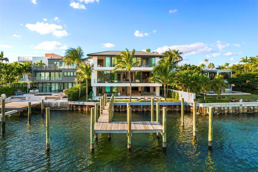 New contemporary 11,420 Sq.Ft. residence with 70 ft of frontage on Biscayne Bay, 6 bedrooms and 6 and a half baths. Offering innovative design and timeless sophistication, the home has high ceilings and glass pocket doors that create the ideal indoor and outdoor experience. Open and light-filled living, dining and family spaces have limestone floors and a balcony with seating area. A state-of-the-art kitchen has Wolf and SubZero appliances, custom cabinetry and a modern marble island. The magnificent main suite has a gorgeous bath with separate vanities, expansive closets and spa shower. Amenities include a multi-boat dock, elevator, separate guest suite, water features, wine cellar, pool, 2-car garage and car port.  A flawlessly designed Bay-front home with captivating water views.