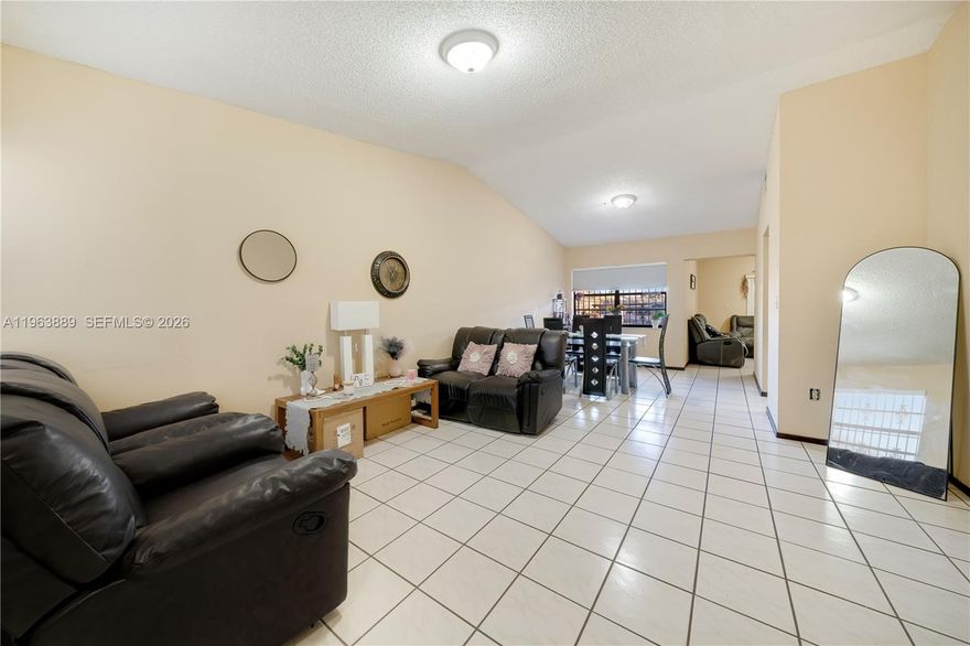 Welcome to this spacious 3-bedroom, 2-bath corner-lot townhome in a highly desirable Miami community! This well-maintained residence features generously sized living areas, an inviting family room, and a charming kitchen with ample cabinet space and a practical pass-through counter perfect for entertaining. The open layout offers natural light throughout, complemented by tile flooring in all living spaces.  Enjoy the privacy and extra outdoor space that comes with a corner lot, plus the durability and peace of mind of a tile roof. The home also includes a comfortable primary bedroom, two additional well-proportioned bedrooms, and two full bathrooms. Sliding doors lead to an outdoor patio area ideal for relaxing or hosting family gatherings.  This home is centrally located near top Miami amenities—shopping, dining, major highways, and excellent schools. Perfect for homeowners or investors seeking a solid property in a fantastic location!