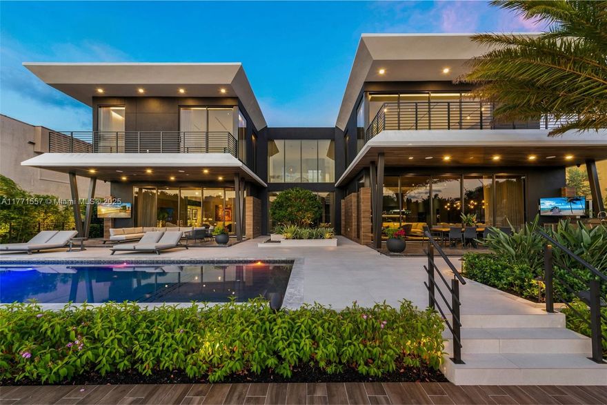 Masterfully crafted, this modern waterfront estate in Las Olas Isles showcases elegant architectural design. Offering 5 beds & 6.5 baths, this private oasis with dramatic soaring ceilings spans 6,619 SF of luxurious living space w/ 100’ on the water. Natural light pours through floor-to-ceiling windows & sliding glass doors creating a bright & airy living area, wet bar, & chef’s kitchen with pro-grade appliances and large pantry. This contemporary estate is made for entertaining w/ an expansive covered outdoor dining & living area, summer kitchen, heated saltwater pool, sauna, and private dock. The oversized primary suite features a spa bath, custom closets, & panoramic water views. Highlights include full home generators, elevator, Savant smart home, 3 car garage w/ 2 lifts & EV chargers.