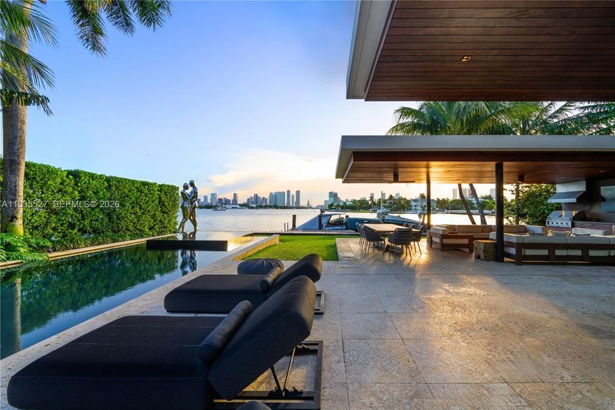 RARE VENETIAN ISLANDS TROPICAL MODERN WATERFRONT ESTATE WITH DIRECT DOWNTOWN MIAMI CITY SKYLINE VISTAS OVER THE BAY ON THE COVETED SOUTH-SIDE OF SAN MARINO ISLAND! Stunning Bayfront Residence Perched on OVERSIZED 15,750SF LOT & A HALF with 90FT of Waterfrontage. Multi-Vessel IPE Dock w/Lift & Jet Ski platforms. 5 Large Suites each with Ensuite Baths + 2 Powder Rooms + Office + Family Room. Theater w/Surround Sound & Lounging Beds. Open modern floor plan, wrapped by 10 FT Telescopic Fleetwood Glass Doors, provides Seamless Indoor/Outdoor Living. Blonde Oak Floors & Gourmet Eat-in Kitchen with Gas Range & Stainless Steel Miele Appliances sits adjacent to Catering Kitchen with Pantry & Separate Service Entrance. Comfortable Breakfast Area, Wine Room & Bar. Spacious Primary Suite draped by Panoramic Sunsets over Miami Skyline with two dressing rooms + Bookmatched Marble Bath with Rain Shower & Deep Soaking Tub. Wraparound Terraces in Keystone with Stairs lead to an Expansive Rooftop Entertaining Area—Ample Green Space with Architectural Dark Bottom Negative-edge Pool & Spa. Modern Gazebo includes a Chef’s Summer Kitchen + Cabana Bath. Privacy Gate + 2 Car Garage.