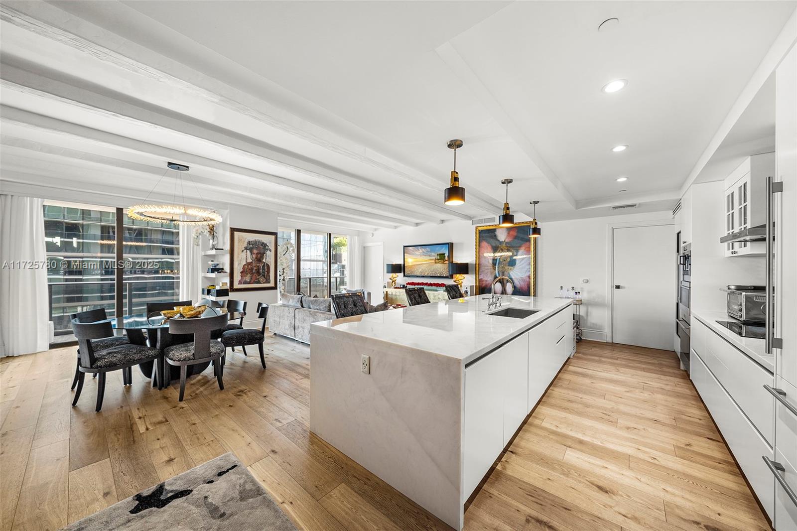One-of-a-kind SLS Lux residence, uniquely upgraded. Seamlessly combining two units, this reimagined home offers a grand living area that takes center stage, featuring ample dining space, lounge space, and upgraded European white oak flooring throughout. The brand-new, fully upgraded kitchen boasts Wolf appliances, a Sub-Zero wine cooler and fridge, and an extended Calacatta stone island. The residence includes three bedrooms, two with walk-in closet and en suite bathroom, as well as a den. SLS Lux Brickell offers top-tier amenities, including three pools, hot tubs, a poolside bar, BBQ area, tennis court, fitness center, spa, concierge service, among others. Conveniently located near Brickell City Centre, Mary Brickell Village, Miami International Airport, South Beach, and Coconut Grove.