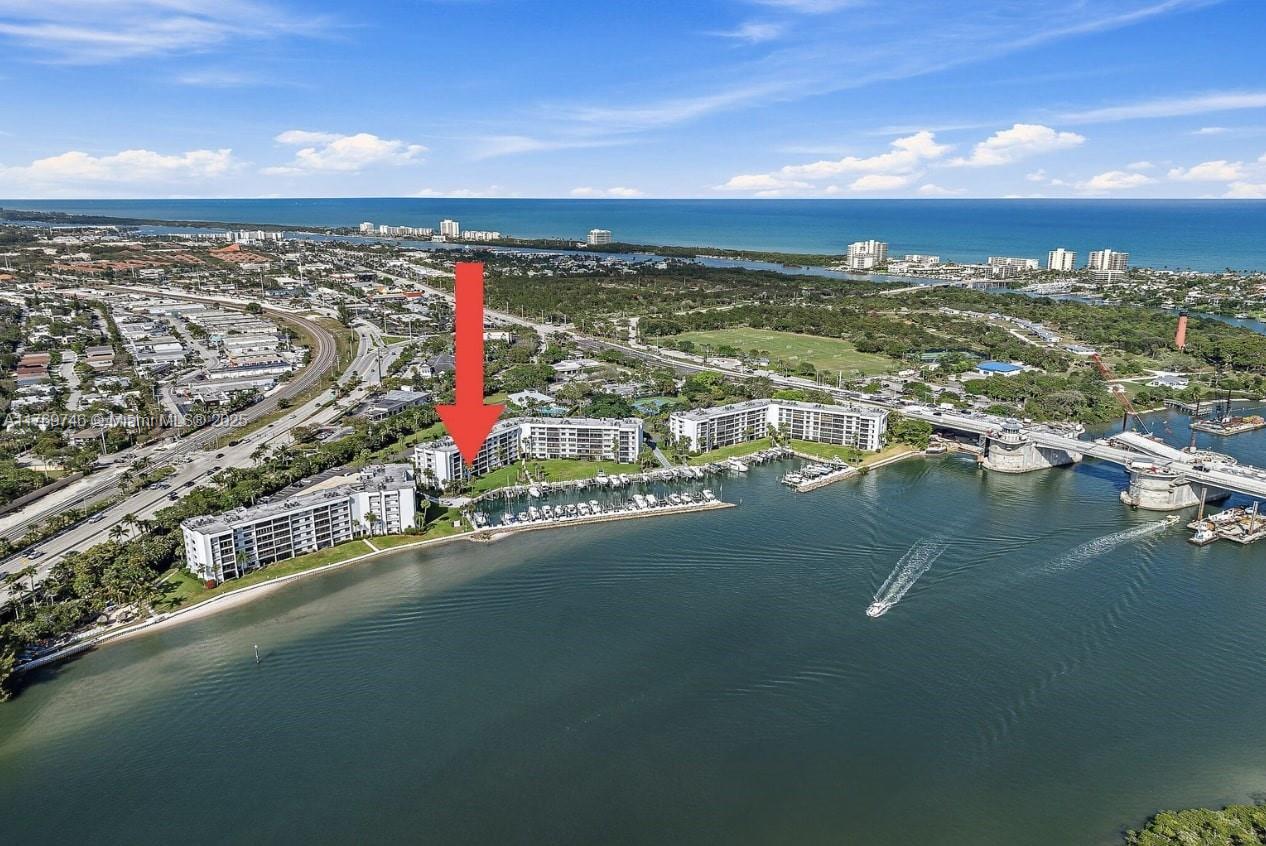 Experience direct Intracoastal views from this meticulously maintained waterfront condo in the highly sought-after Jupiter Cove. This boater's paradise offers an unobstructed blue-water lifestyle, perfect for those seeking a luxurious, maintenance-free condo experience in one of Jupiter's most desirable locations. Step inside this spacious 2-bedroom, 2-bathroom residence boasting 1,500 sq. ft. of living space with an open and airy layout. Natural light floods in through large windows, showcasing breathtaking views of passing yachts and the iconic 1000 North restaurant waterfront scene. The updated gourmet kitchen features modern appliances and a sleek design, making it a chef's dream. Hardwood floors add warmth and elegance throughout the home.