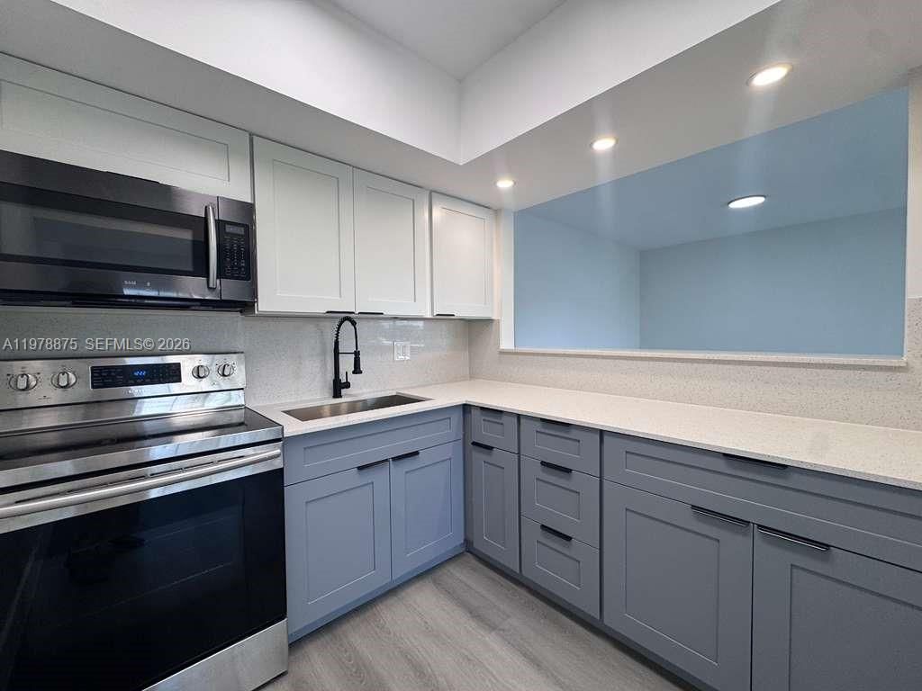 Photo of 455 Golden Isles Dr #203, Hallandale Beach, FL 33009 (MLS # A11978875)