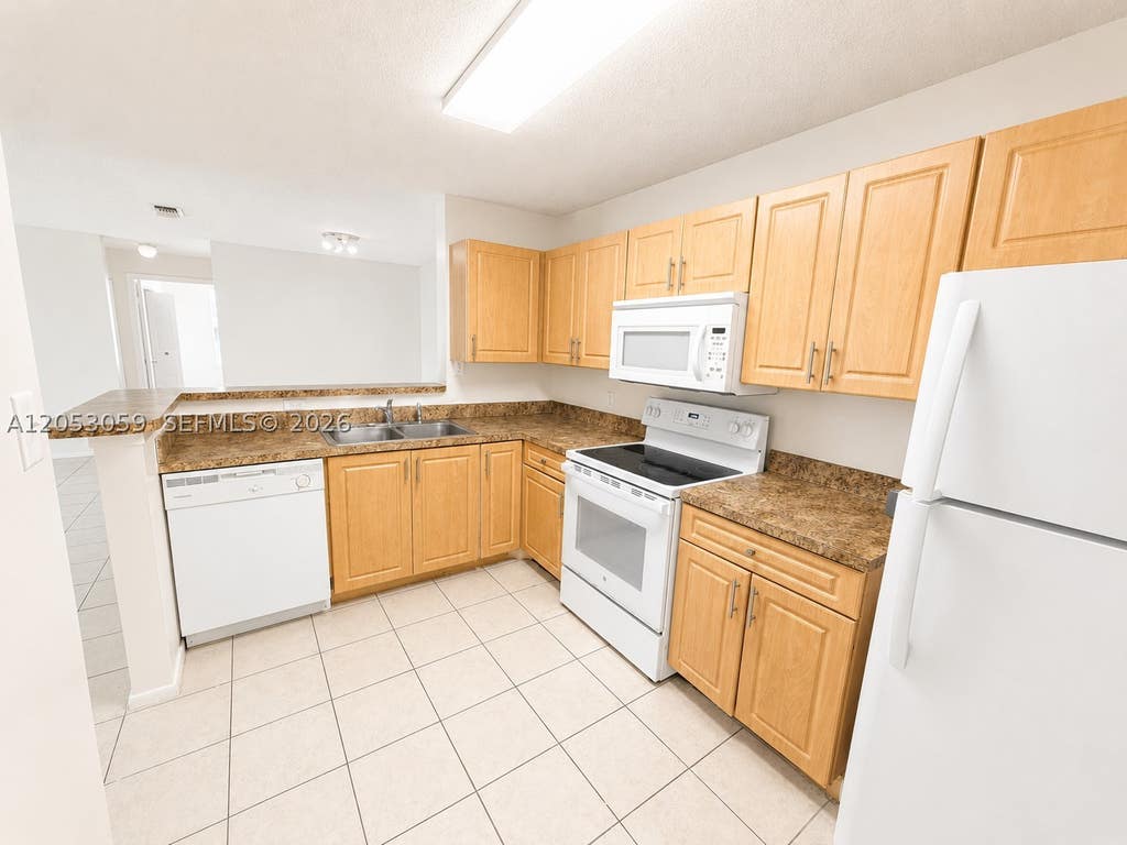 Photo of 11211 W Atlantic Blvd #108, Coral Springs, FL 33071 (MLS # A12053059)