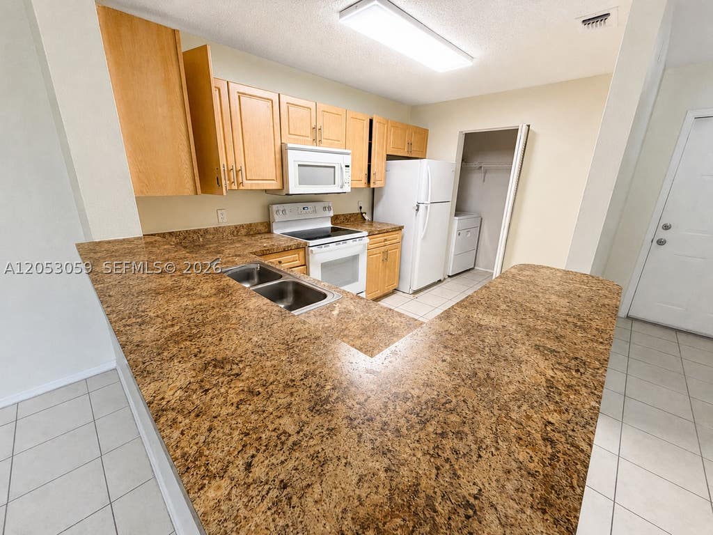 Photo of 11211 W Atlantic Blvd #108, Coral Springs, FL 33071 (MLS # A12053059)