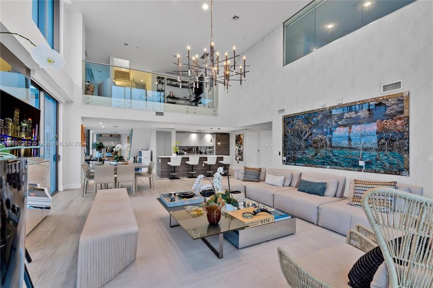 Triplex Penthouse in Midtown Miami's Hyde Residences. Featuring 4 beds, 4.5 baths with panoramic city views, PH3217 includes 3 parking spaces: 2 deeded spots located side-by-side, plus 1 valet parking space and 2 PRIVATE STORAGE ROOMS. Property features an impressive abundance of natural light streaming in through its expansive two-story, ground-to-ceiling windows, offering stunning skyline views at night. The 1st floor includes 2 luxurious en-suite bedrooms, a chef's kitchen, and a powder room. The 3rd floor ROOFTOP RETREAT hosts a SKY KITCHEN and its very-own PRIVATE JACUZZI, perfect for relaxation & entertainment.