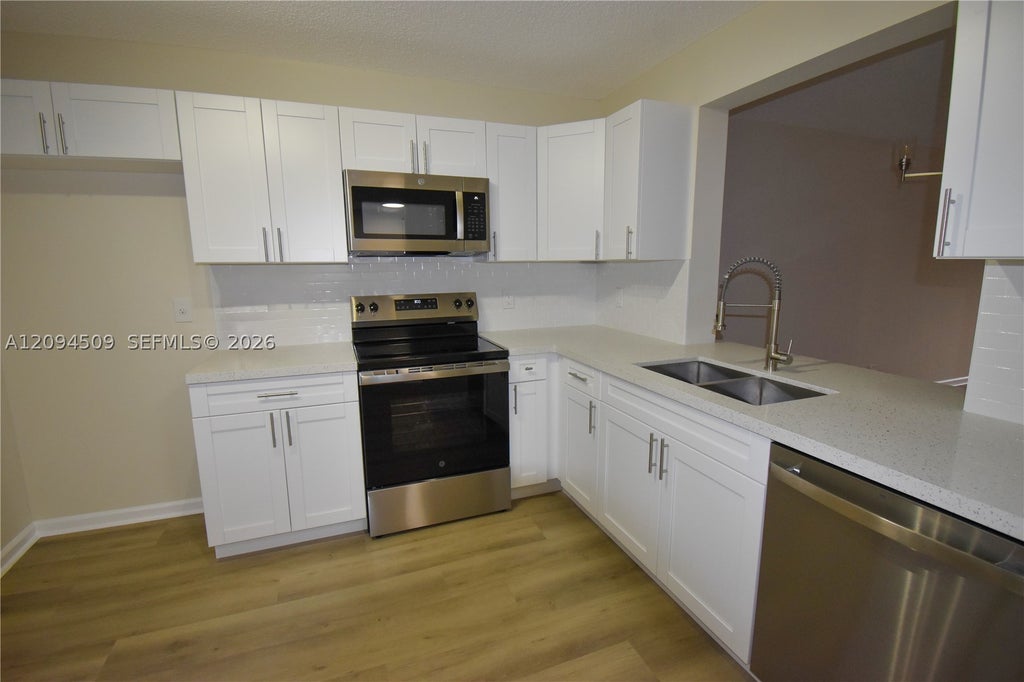 Photo of 8592 W Sunrise Blvd #303, Plantation, FL 33322 (MLS # A12094509)