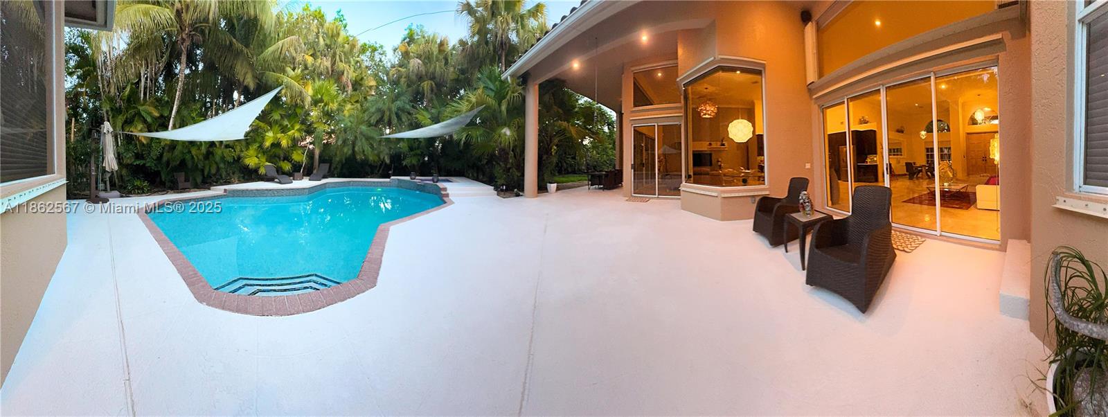 Discover the Crystal House of Weston—where walls of glass transform lifestyles into art. This 5-bed/5-bath residence seamlessly blends all indoor spaces into one luminous, open concept layout, framed by floor-to-ceiling glass that connects to the outdoors. Featuring soaring ceilings, porcelain & marble floors, plus new 2025 bamboo floors. The renewed Cambria kitchen invites entertaining. Fresh 2025 interior&exterior paint. Enjoy a resort-style backyard with remodeled 2025 pool, spa, deck & cabana bath with Diamond Brite and new tile. Patio extends living areas, framed by exuberant landscaping & majestic palms. A grand driveway 5+ cars, plus a 2-car garage, completing this home. Located in exclusive Palm Island with dual private entrances (Indian Trace & Royal Palm) and access to A+ schools