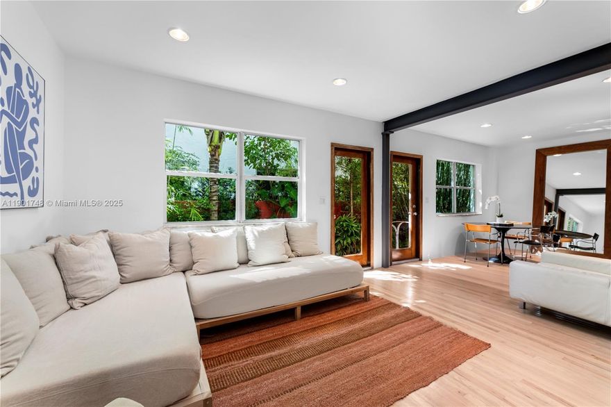 South of Fifth Beach Bungalow located on a premiere quiet block, nestled in a lush tropical botanical garden. This 1BD/2BA, 922 SF sanctuary blends natural textures with modern design. Warm white oak floors and Ipe wood walls create a serene, organic backdrop accented by Italian custom-built furniture and décor. The kitchen is a showpiece, featuring green marble counters, floating cabinetry, Blanco sinks, and a Fulgor Milano oven. The blue Spanish-tiled bathrooms with skylights evoke coastal Mediterranean charm, while the LG laundry area and Whirlpool dishwasher add everyday convenience. Experience true Miami Beach living in the heart of SoFi: a coveted area that is just steps to world-class dining and the beach.