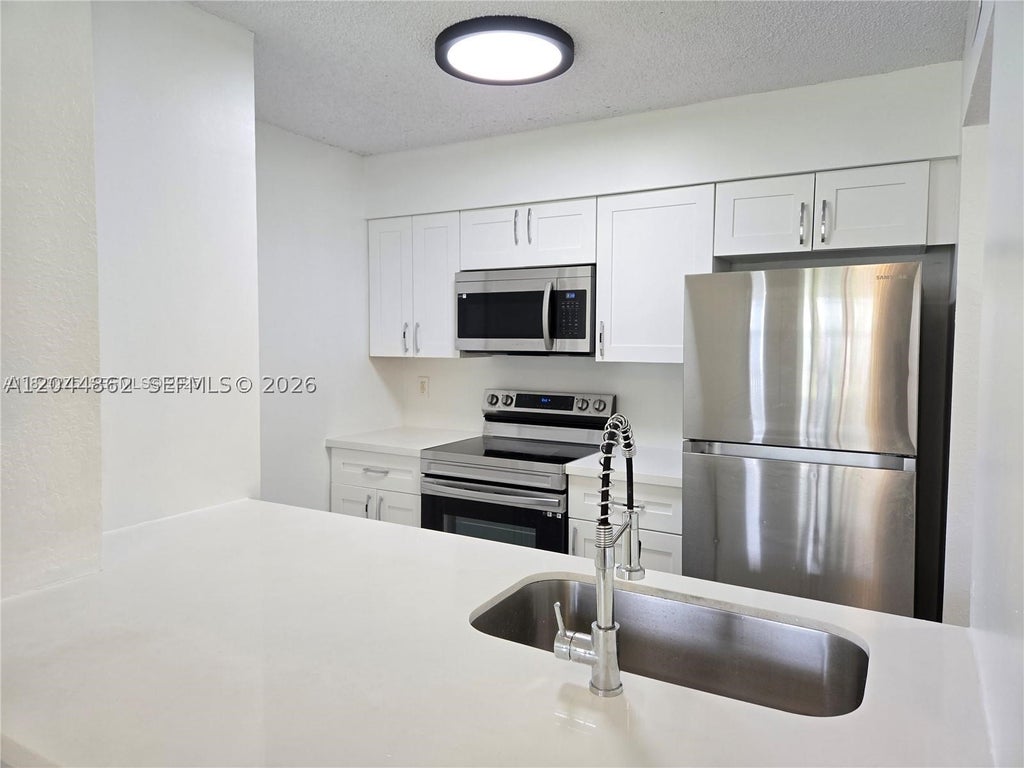 Photo of 2890 N Oakland Forest Dr #102, Oakland Park, FL 33309 (MLS # A12044862)