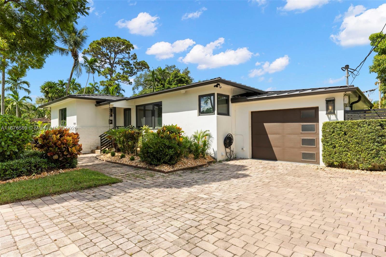 Stunning Miami Shores Executive Residence, thoughtfully renovated throughout with the finest finishes and fixtures. Recent new construction additions to the home include the primary suite with spa-like bath and enormous walk-in closet, and a chef's dream kitchen including custom cabinetry, GE Monogram appliances and professional double-oven and gas cooktop. Spacious dining and living area overlooks private covered patio for entertaining. 2 additional bedrooms, and 2 full bathrooms, one with jacuzzi tub. Guest half-bath with marble vanity, laundry room with cabinetry, generous closet space throughout. Custom summer kitchen, putting green, 1-car garage, and large yard with room for a pool. New metal roof, impact glass throughout. Quiet Miami Shores Village location. OPEN Sat 11am-1pm