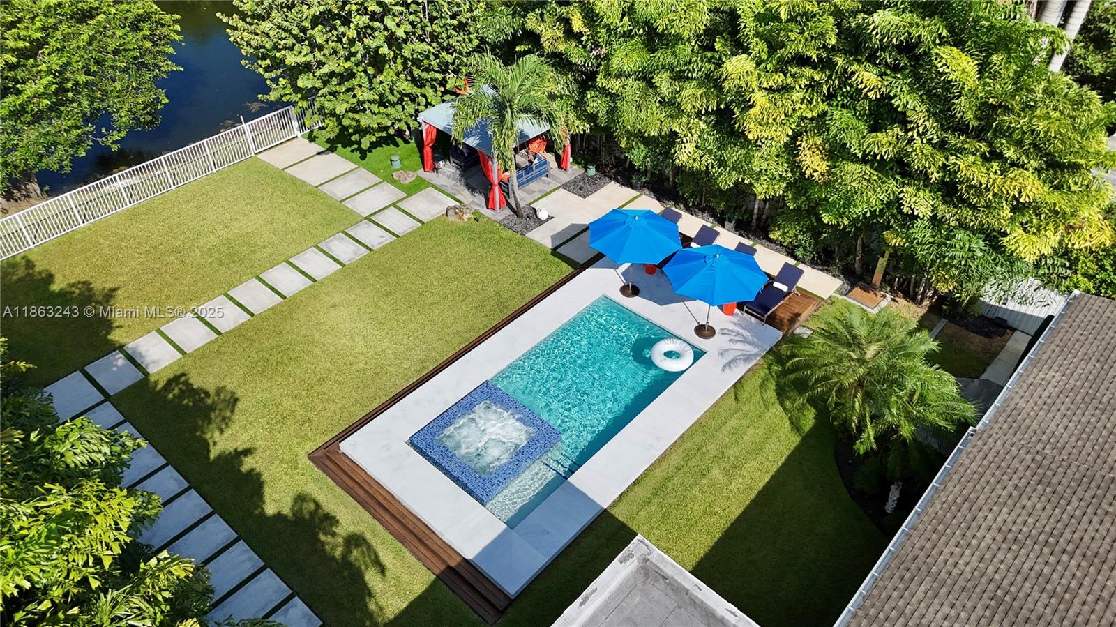 Modern waterfront living in this fully updated 3 BD, 2 BA contemporary home with 1,640 SF of LA in Miami. Perfectly situated along the Biscayne Canal with ocean access, this property feats an electric front gate & sits on a lushly landscaped, fully fenced lot. Enjoy a new heated pool w/ jacuzzi and breathtaking water views from the patio and primary bedroom. Designed for effortless indoor-outdoor living w/ a covered patio, gazebo, summer kitchen, and solar-powered LED exterior lighting. Inside, porcelanato floors enhance the open layout, w/ a modern kitchen, updated bedrooms & bathrooms, and a third bedroom with independent access. Additional highlights include a newer roof (2020) and impact windows. No HOA! This is a rare turnkey waterfront opportunity. Schedule your private tour today!