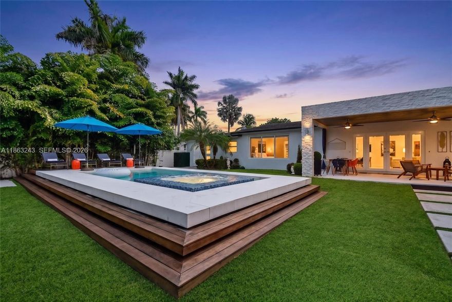 Modern waterfront living in this fully updated 3 BD, 2 BA contemporary home with 1,640 SF of LA in Miami. Perfectly situated along the Biscayne Canal with ocean access, this property feats an electric front gate & sits on a lushly landscaped, fully fenced lot. Enjoy a new heated pool w/ jacuzzi and breathtaking water views from the patio and primary bedroom. Designed for effortless indoor-outdoor living w/ a covered patio, gazebo, summer kitchen, and solar-powered LED exterior lighting. Inside, porcelanato floors enhance the open layout, w/ a modern kitchen, updated bedrooms & bathrooms, and a third bedroom with independent access. Additional highlights include a newer roof (2020) and impact windows. No HOA! This is a rare turnkey waterfront opportunity. Schedule your private tour today!