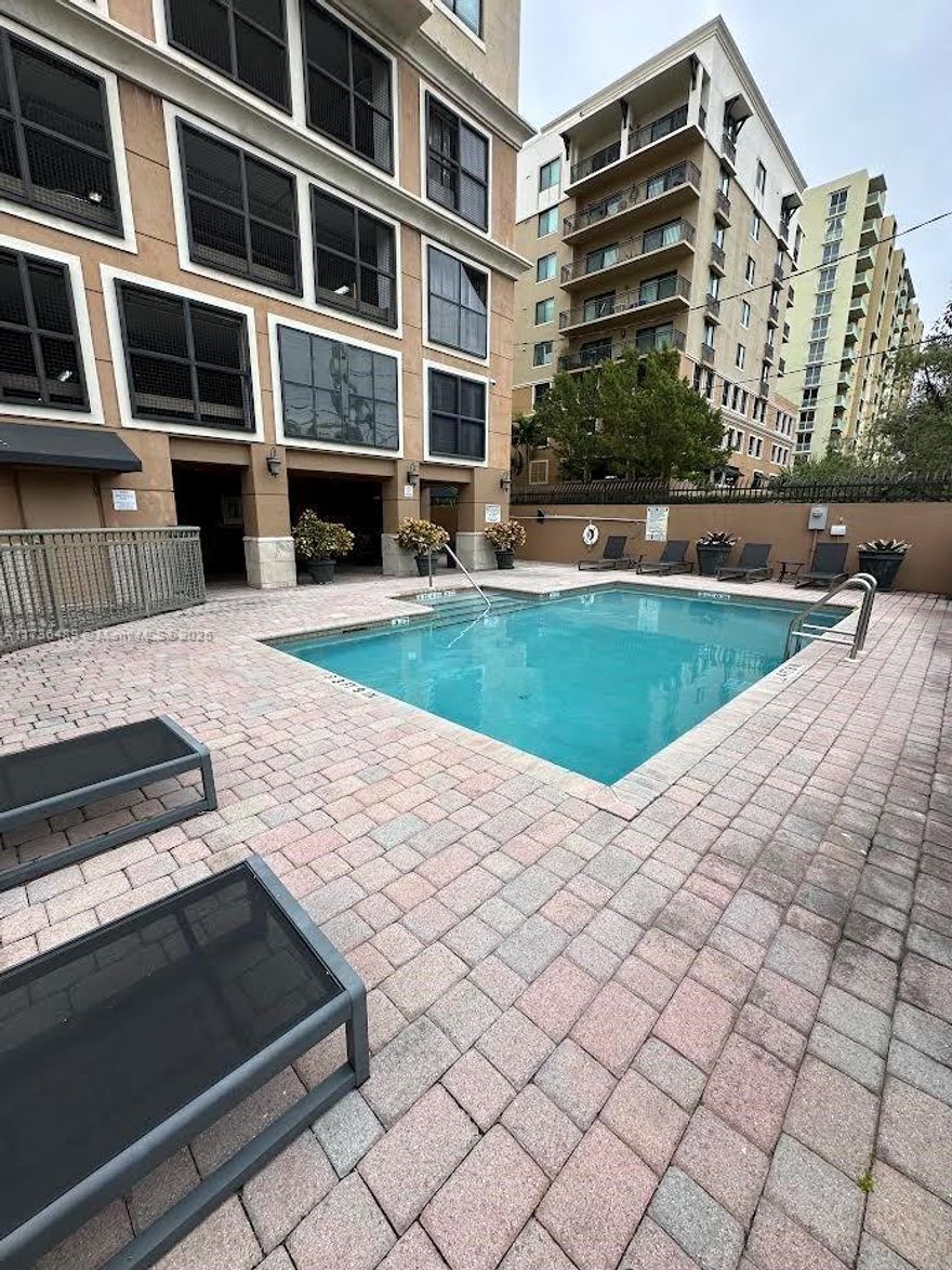 Keystone Villas! This is one of Miami's trendiest addresses in the heart of prestigious Coral Gables. Walk to the famous Miracle Mile (1 block away) or drive minutes to Coconut Grove, Key Biscayne, Downtown & South Beach. Keystone Viillas is modern, and immaculate and has everything you need: Take a dip in the pool with an entertaining area; workout in the fitness room, and club room; and work in the spacious conference center. SPLIT FLOOR PLAN plus a large laundry room with full washer & dryer. Built-in closet cabinetry. + 2 ASSIGNED PARKING.
