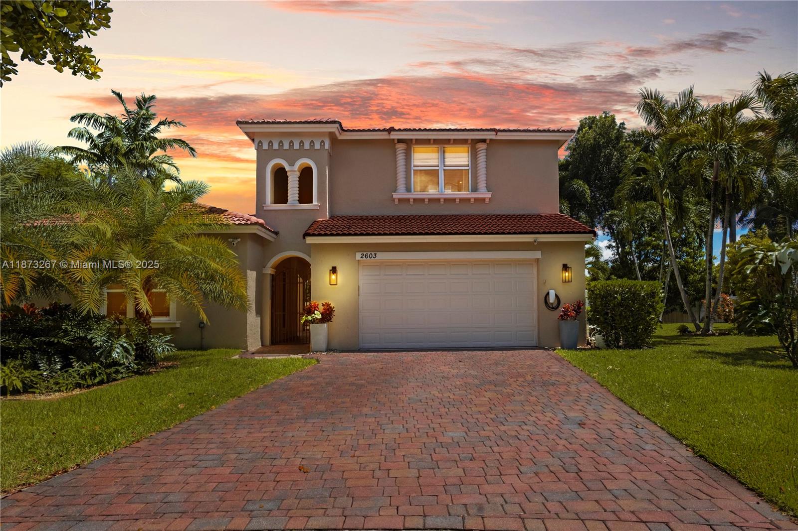 Discover South Florida living at its finest in your dream home! One of the few oversized lots in the sought-after community of Biltmore Estates at Monarch Lake in Miramar. Perfectly designed for entertaining and everyday ease and comfort.The outdoors is designed for relaxation, surrounded by lush tropical landscaping, pool area, and a large yard with a private back patio. The meticulously designed kitchen features quartz countertops, waterfall island, wine fridge and custom designed coffee station. Custom woodwork and built-ins throughout make this home a one-of-a-kind. Courtyard features private guest/in-laws quarters. The primary ensuite includes an added room perfect for office, nursery, or 5th bedroom. Impact windows and doors throughout. This home is both inviting and sophisticated.