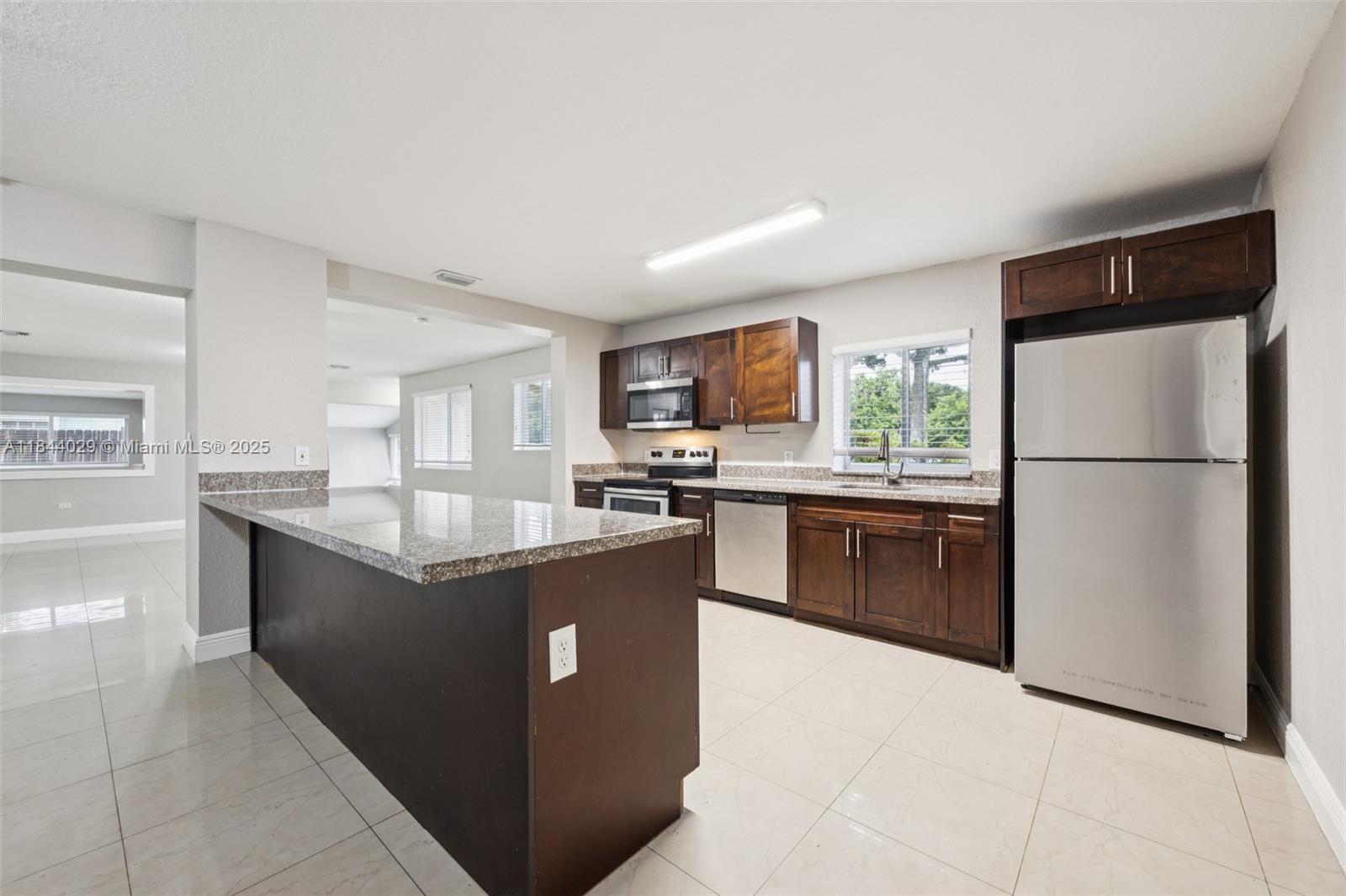 Four-Bedroom, Three-Bathroom Home in Miramar
This move-in ready home in Miramar features an open-concept layout with soaring vaulted ceilings and tile flooring throughout. The kitchen stands out with stainless steel appliances, granite countertops, and a large island, offering ample workspace for chefs of all levels. Prime location near Seminole Hard Rock Casino, major expressways, tons of dining, and shopping. Don’t miss your opportunity and schedule your showings today!