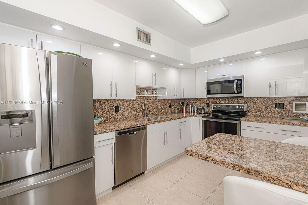 Completely Updated! Beautiful Wood Flooring. Light Bright Kitchen. Full Size Washer and Dryer in the unit. Amazing Closet Space. Spacious living area looks out to the oversized screened Balcony that is the length of the entire condo. Very pleasant view. Formal Dining room can also be a third Bedroom. Covered Parking. Modern amenities including Heated pool and Jacuzzi. Gazebos with Grills. Gym w/ locker areas. game room and pool tables. library. Car Wash and more. Building has passed 40 yr inspection. No Assessment. Low Maintenance. Bldg. has reserves. Conveniently located near 95 and 441 the beaches shopping and dining and walking distance to the shull. Can be purchased completely Turnkey. Shown by appointment.