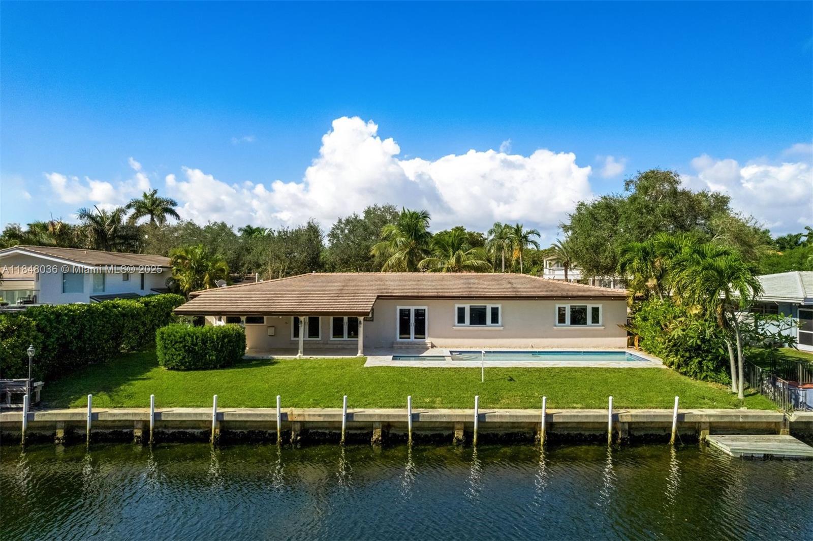 Updated ranch-style single-story home in the sought-after Gables by the Sea community. Situated on a quiet double cul-de-sac w/convenient access to the community park w/basketball court & playground. A boaters dream with OCEAN ACCESS to Biscayne Bay from the 100’ seawall & davits. Sleek marble & wood floors. Over 3000 SF offering 4BD 3 full BA, walk-in closets. Extra 5th room w/ensuite cabana bath, ideal for home office, gym or bdrm. Expansive open modern kitchen w/hi-end appliances, 6-burner gas range & wine cooler. FL room complete w/full bar, leads out to the east-facing covered veranda for refreshing al fresco poolside dining. Luxurious pool & spa are heated for year-round enjoyment. Interior Laundry/utility room and a 2-car garage with circular driveway. Full Impact glass, newer AC.