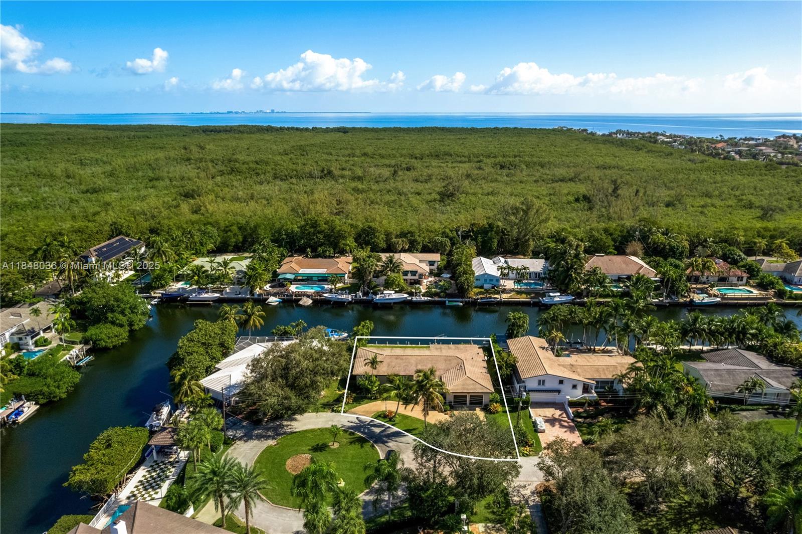 Updated ranch-style single-story home in the sought-after Gables by the Sea community. Situated on a quiet double cul-de-sac w/convenient access to the community park w/basketball court & playground. A boaters dream with OCEAN ACCESS to Biscayne Bay from the 100’ seawall & davits. Sleek marble & wood floors. Over 3000 SF offering 4BD 3 full BA, walk-in closets. Extra 5th room w/ensuite cabana bath, ideal for home office, gym or bdrm. Expansive open modern kitchen w/hi-end appliances, 6-burner gas range & wine cooler. FL room complete w/full bar, leads out to the east-facing covered veranda for refreshing al fresco poolside dining. Luxurious pool & spa are heated for year-round enjoyment. Interior Laundry/utility room and a 2-car garage with circular driveway. Full Impact glass, newer AC.