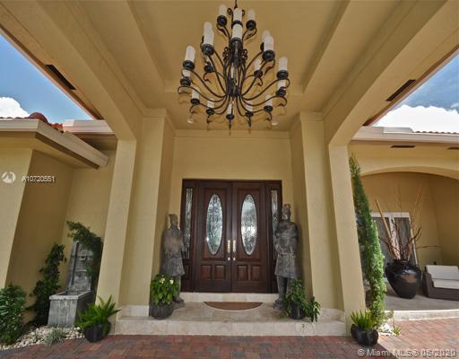 Gorgeous Custom build one Story Waterfront Home, marble and porcelain floors, Impact windows, Dream Italian design kitchen and a second kitchen at the family, 4 bedrooms, 3 bath with great  Driveway at entrance. 80' water frontage with no fixes bridges. Automatic lift for a 30' boat and 2 others for jet sky .YACHTMANS DREAM IN GATED COMMUNITY WITH A RATED SCHOOLS  Easy to show